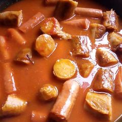 A picture of Sausages in sauce.