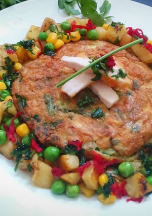 A picture of Omelette with spinach and chicken.