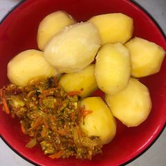 A picture of Boiled irish potato with carrot egg sauce.