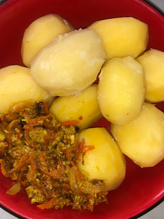 A picture of Boiled irish potato with carrot egg sauce.