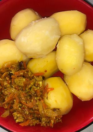 A picture of Boiled irish potato with carrot egg sauce.