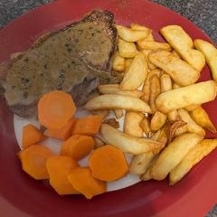 A picture of Medium Sirloin Steak and homemade peppercorn sauce.
