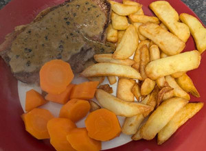 A picture of Medium Sirloin Steak and homemade peppercorn sauce.