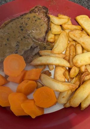 A picture of Medium Sirloin Steak and homemade peppercorn sauce.