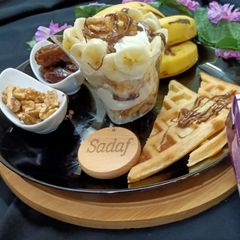 A picture of English breakfast waffle and creamy fruit.
