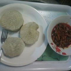 A picture of Boiled yam with palmoil sauce and ugba.