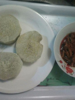A picture of Boiled yam with palmoil sauce and ugba.