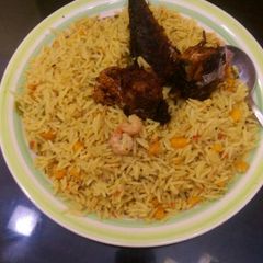 A picture of Jollof rice with prawns,carrots and titus fish.