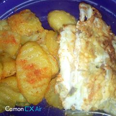 A picture of Fried potatoes and omellete.