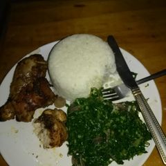 A picture of Rice and kale with chicken.