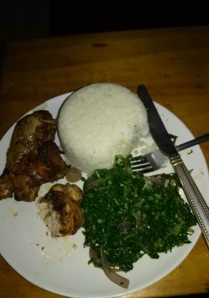 A picture of Rice and kale with chicken.