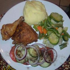 A picture of Mashed potatoes, fried chicken and greens.
