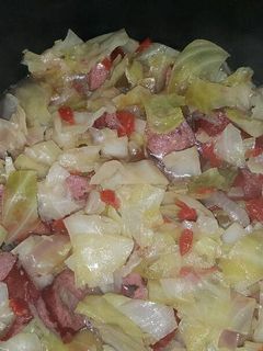 A picture of Boiled cabbage and beef sausage.