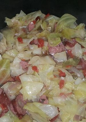 A picture of Boiled cabbage and beef sausage.