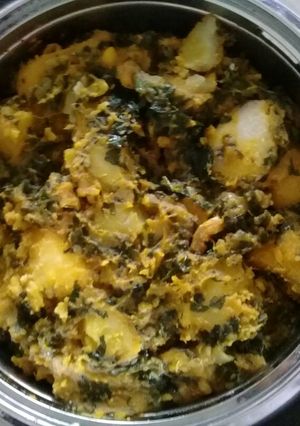 A picture of Yam porriage with fresh vegetables(green).