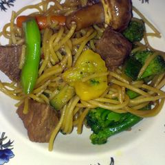 A picture of teriyaki noodles with beef and veggies.
