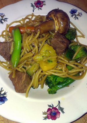 A picture of teriyaki noodles with beef and veggies.