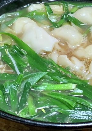 A picture of Chinese Hot Pot with Frozen Dumplings and Ramen Soup Base.