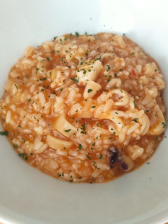 Una foto de Arroz meloso de chipis y merluza