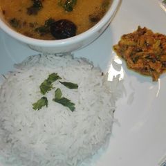 A picture of Moong Masoor Daal With White Rice and Mango Grated Achar.