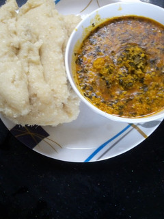 A picture of Egusi soup and Garri.