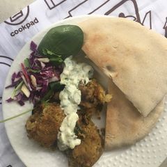 A picture of Chickpea falafel with toasted pita breads and tzatziki.