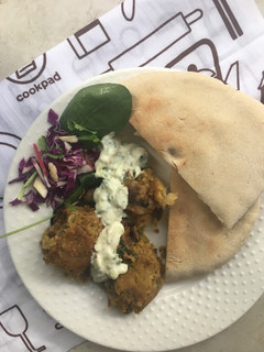 A picture of Chickpea falafel with toasted pita breads and tzatziki.