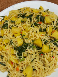 A picture of Noodles with irish & spinach.