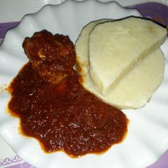 A picture of Boiled yam with tomato stew.