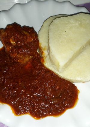 A picture of Boiled yam with tomato stew.