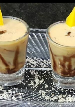 A picture of Mango milkshake shots with chocolate syrup.