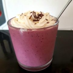 A picture of My mixed berry slushy with cream on top.