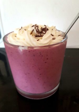 A picture of My mixed berry slushy with cream on top.