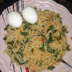 A picture of Stir fry noodles with spinach.
