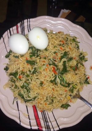 A picture of Stir fry noodles with spinach.