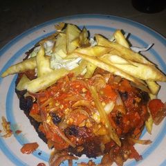 A picture of Grilled fish with sauce.