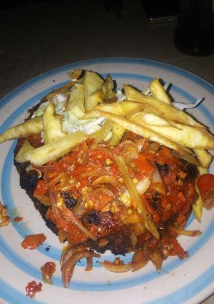 A picture of Grilled fish with sauce.