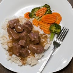A picture of Beef Tips with Rice and Gravy.