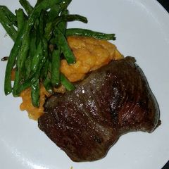A picture of Rib Eye Steak with Potato-Carrot Mash.