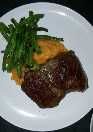 A picture of Rib Eye Steak with Potato-Carrot Mash.
