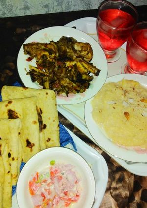 A picture of Chicken karaily and sheer khurma with rooti salad and drink.