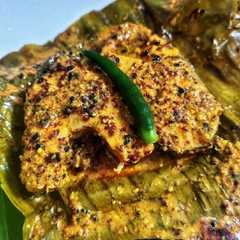 A picture of Macher paturi (fish wrapped in banana leaf).