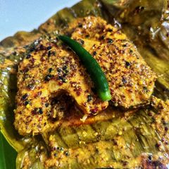 A picture of Macher paturi (fish wrapped in banana leaf).