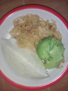 A picture of Ugali served with cabbage and avocado.