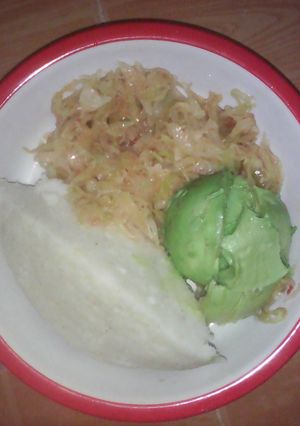 A picture of Ugali served with cabbage and avocado.