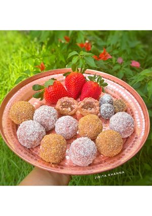 A picture of Strawberry Coconut Laddoo with Almond Chocolate Mawa filling.