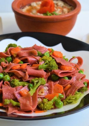 A picture of Wholewheat beetroot pasta with stir fried vegetables.