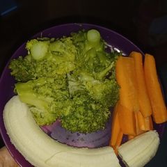 A picture of Boiled Broccoli with Raw Carrots and Banana.