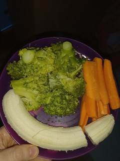 A picture of Boiled Broccoli with Raw Carrots and Banana.