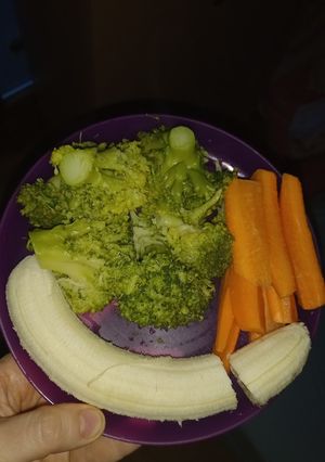 A picture of Boiled Broccoli with Raw Carrots and Banana.